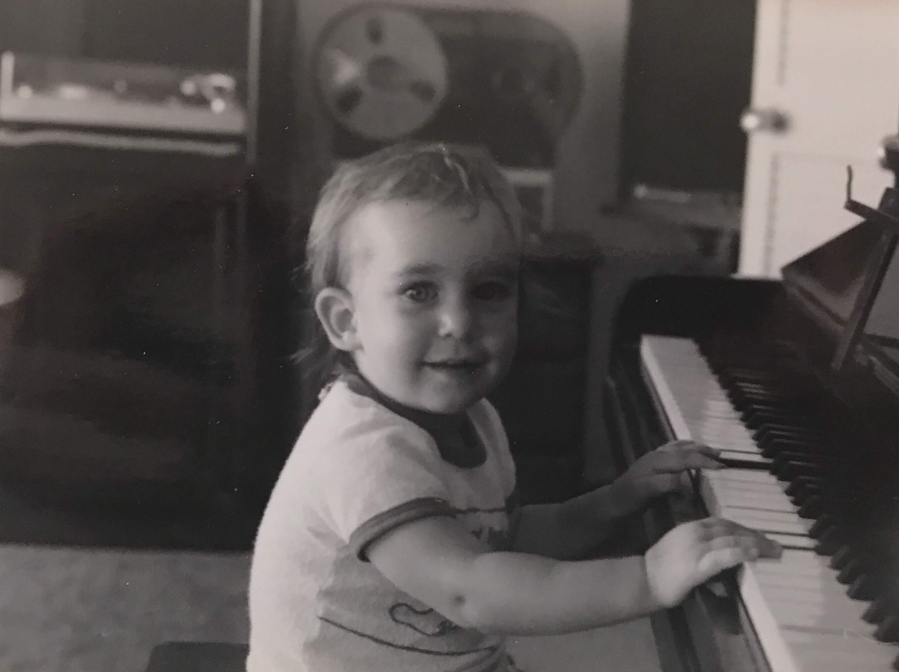 Emma as a kid at the piano